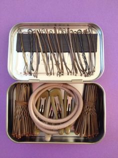 an open metal container filled with lots of different types of scissors and other items in it