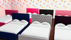 four beds with different colored headboards in a room