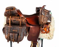 two leather saddles are stacked on top of each other