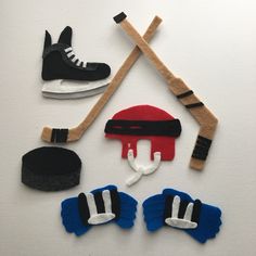 an assortment of sports related items are displayed on a white surface, including hockey gloves and ice skates