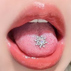 a woman's tongue with pink and white glitter on it