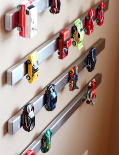 several toy cars are hanging on the wall