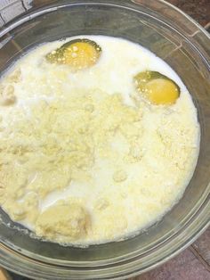 two eggs are being cooked in a bowl on the counter top, with other ingredients