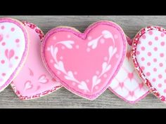 three heart shaped cookies sitting next to each other on top of a wooden table with the words step by step instructions