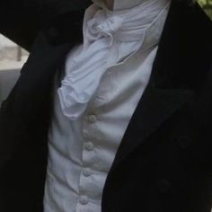 a man wearing a white shirt and black jacket