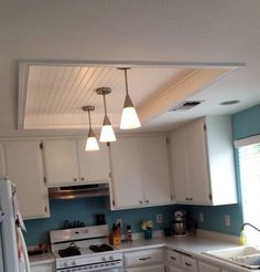 the kitchen is clean and ready for us to use it's new lighting fixtures