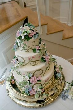 a three tiered wedding cake sitting on top of a table