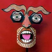 a mask with an open mouth and two eyes on a red background is shown in the foreground