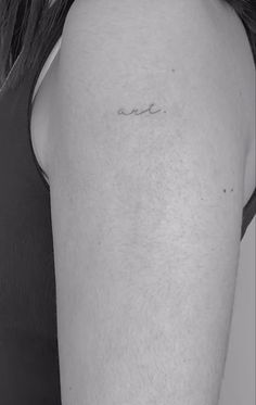 a woman's arm with the word love tattooed on her left side ribcage