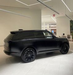 an suv is parked in a large room