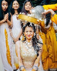 a woman is covered in water while getting her hair washed and put into a bucket