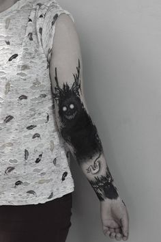 a person with a black and white tattoo on their arm