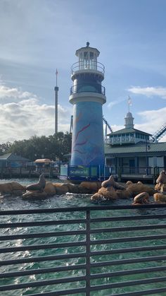 a light house sitting on top of a pier next to the ocean