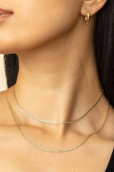 Get serious about your shine with our Mystic Mariner Pavé Choker. This timeless chain features flat, mirror-like links with a top layer of diamond cut white gold for a shine that catches the light from every direction. Adorn it on your neck to add sophistication to any look. Metal: 14 Karat Yellow Gold Dimensions: 2.5 Wide, 14 Inches Length Weight: 2.4 Grams Solid Gold Construction: Hollow Links, Spring Ring Clasp Origin: Crafted in Vicenza, Italy 14k Gold Delicate Silver Chain Necklace, 14k Gold Silver Chain Necklace With Delicate Chain, 14k Gold Delicate Chain Necklace In Silver, Dainty White Gold Jewelry With Figaro Chain, Dainty White Gold Figaro Chain Jewelry, White Gold Figaro Chain Necklace, White Gold Fine Jewelry Chain Necklace, Tarnish Resistant, Fine Jewelry White Gold Chain Necklace, Tarnish Resistant, Tarnish Resistant White Gold Fine Chain Necklace