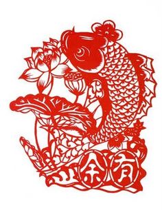 a red paper cut fish and flowers on a white background