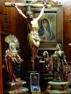 the crucifix is surrounded by other statues