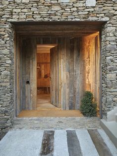 an open door leading into a stone building