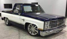 a blue and white truck parked in a garage