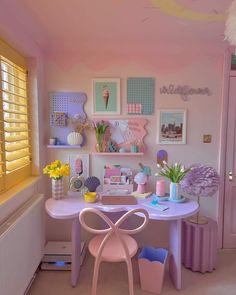 a room filled with lots of pink furniture and pictures on the wall next to a window