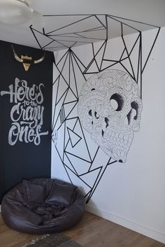 a black and white room with a chair in front of a wall that says hello, crazy ones