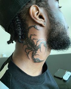 a man with a scorpion tattoo on his neck