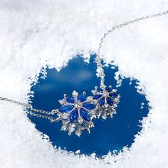 Every winter, we look forward to the first sight of a snowflake. Enjoy the beauty year round with this bewitching sterling silver snowflake necklace. The darling design highlights different-sized snowflakes made of twinkling white and blue stones, which enhances her beauty and refreshes her spirit. Wear this beautiful pendant while gathering by the fireplace in winter holidays, or simply to feel cooler on a hot summer day, or just to add a touch of wintry magic to your everyday look. Polished to Blue Snowflake Sterling Silver Necklace, Silver Snowflake Necklace With Cubic Zirconia, Silver Cubic Zirconia Snowflake Necklace, Sterling Silver Snowflake Jewelry For Winter, Silver Snowflake Necklace For Anniversary, Sterling Silver Snowflake Necklace In White Gold, White Gold Snowflake Necklace, White Gold Sterling Silver Snowflake Necklace, White Gold Snowflake Necklace In Sterling Silver