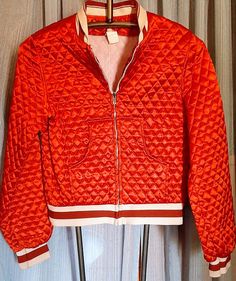 This jacket is so cute.  Bright red quilted, satiny fabric.  No tag but does advise dry cleaning.  Armpit to armpit is 18 inches.  Waist is 32 inches. Has elastic cuffs, collar and waistband.  Sale is final. Sporty Long Sleeve Quilted Puffer Jacket, Red Quilted Long Sleeve Outerwear, Red Stretch Sporty Outerwear, Sporty Stretch Red Outerwear, Sporty Red Stretch Outerwear, Retro Quilted Long Sleeve Outerwear, Quilted Retro Outerwear, Casual Quilted Red Outerwear, Casual Red Quilted Outerwear