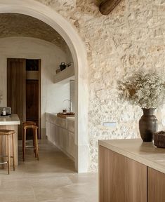 a kitchen with an archway leading to the dining room and living room, along with a bar