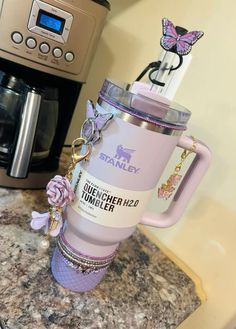 a pink coffee mug sitting on top of a counter