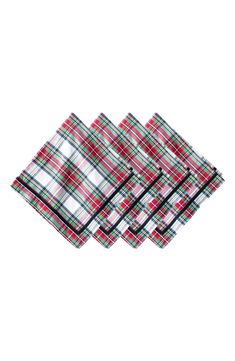 four red and green plaid napkins sitting on top of each other in front of a white background