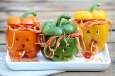 three small pumpkins are on a plate with string wrapped around the heads and eyes