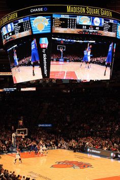 a basketball game is being played on the big screen at madison's palace garden