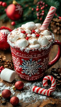 a red mug filled with hot chocolate and marshmallows