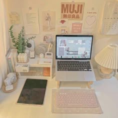 an open laptop computer sitting on top of a white desk