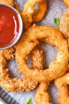 fried onion rings with ketchup on the side