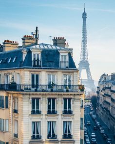 the eiffel tower is in the background of this view from an apartment building