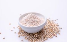 a white bowl filled with oatmeal sitting on top of a pile of cereal