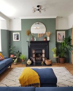 a living room filled with furniture and a fire place under a mirror on the wall