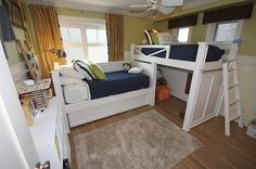 a bedroom with bunk beds and a rug on the floor