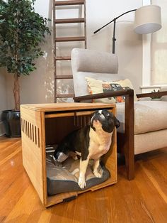 a dog sitting in an open crate on the floor