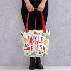 a woman holding a bag with the words jungle bells on it