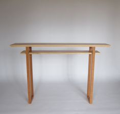 a wooden table sitting on top of a white floor