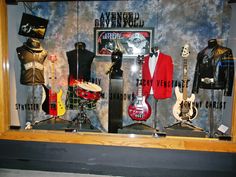 a display case with guitars and other musical instruments