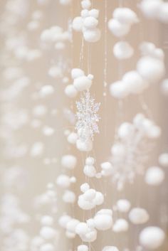 snowflakes hanging from the ceiling in front of a window