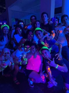 a group of young people posing for a photo in front of the camera at a party