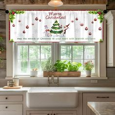 a kitchen window covered in christmas decorations