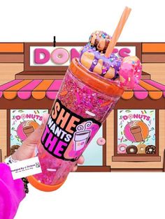 a person holding up a pink drink with sprinkles and donuts on it