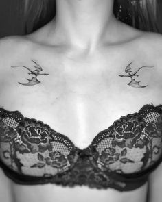 a woman wearing a bra with two birds on it's chest and one bird in the middle