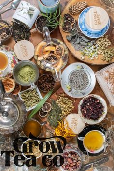 a table topped with lots of different types of teas and seasonings on top of it