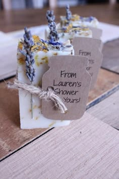 three soap bars with tags on them sitting next to each other